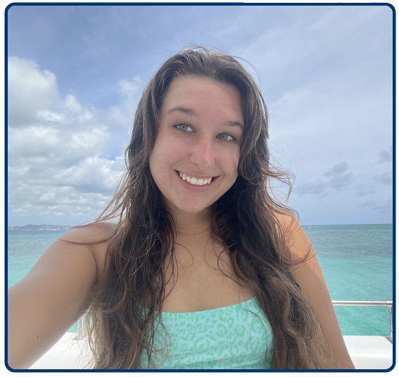 a woman smiling next to a body of water