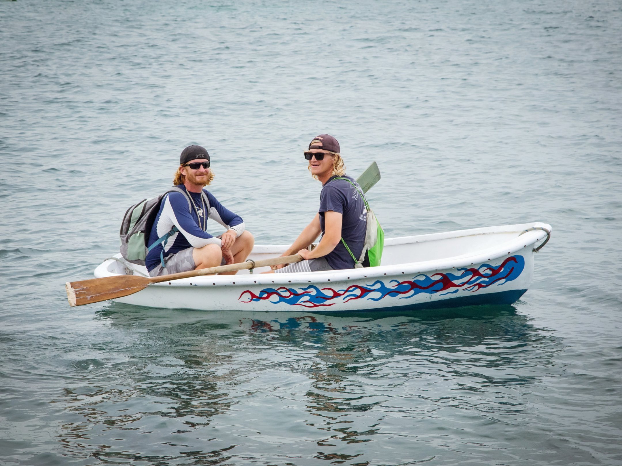 a person riding on the back of a boat in the water