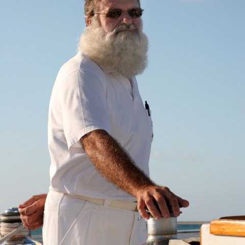 a man standing on top of a cutting board