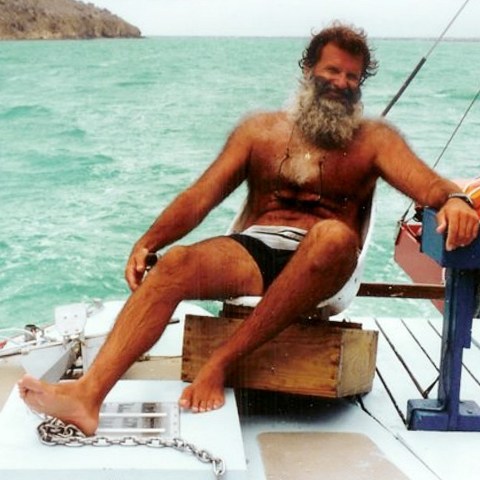 a man sitting on a boat in the water