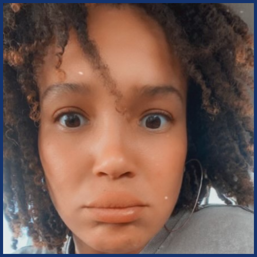 Person with curly hair and surprised expression.